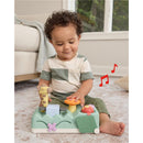 Baby playing with the Skip Hop Tummy Time musical toy featuring animal sounds, lights, and interactive buttons.