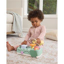 Baby playing with Skip Hop Tummy Time toy featuring animals, lights, and buttons for sounds and music, encouraging sensory exploration.