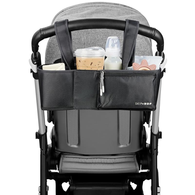 Stroller organizer featuring compartments for drinks and baby essentials, attached to a stroller handle.
