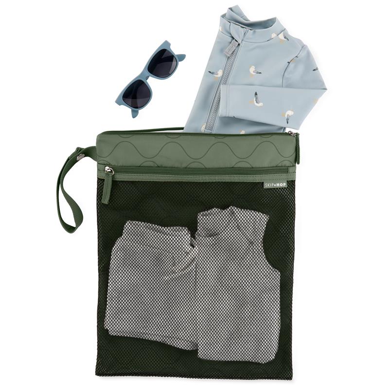 Waterproof wet dry bag in sage color containing a swimsuit, gray shorts, and sunglasses on top.