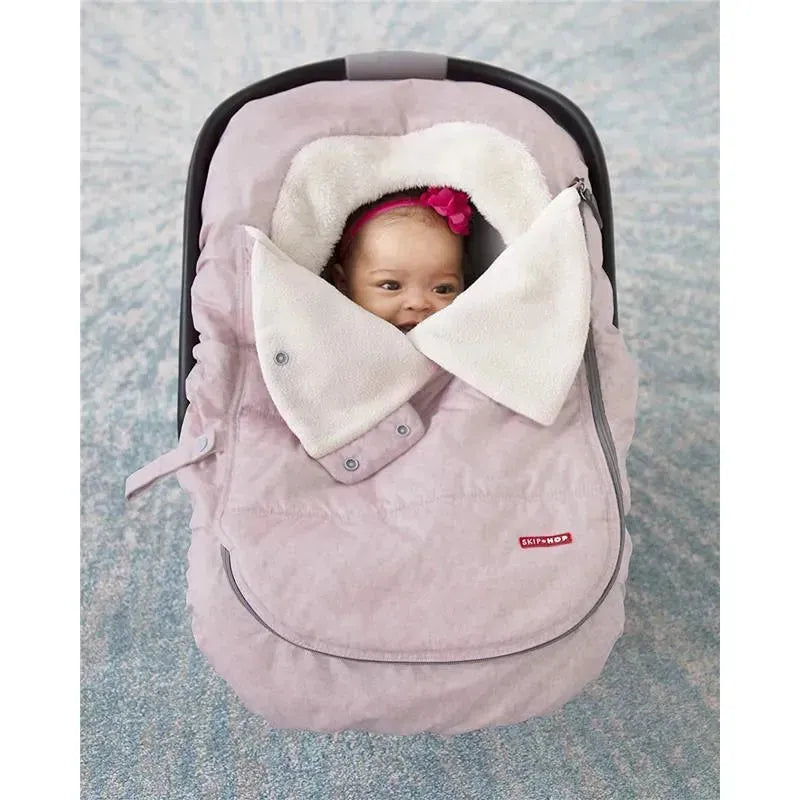 Winter car seat cover in pink heather with a soft, fluffy lining, featuring a baby peeking out, secured inside.