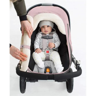 Winter car seat cover in pink heather with a baby securely strapped in, surrounded by soft fleece lining.