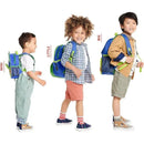 Mini backpacks in three sizes (mini, little, big) modeled by three children, showcasing the Skip Hop Zoo Dino design.
