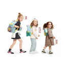 Skip Hop Zoo Unicorn backpacks displayed on three young children, showcasing sizes labeled Big, Little, and Mini.