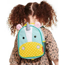 Unicorn-themed mini backpack by Skip Hop, featuring colorful polka dots and a playful design, worn by a child.