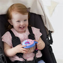 Toddler with red hair smiling while holding a butterfly-themed Skip Hop Zoo Snack Cup in a stroller.