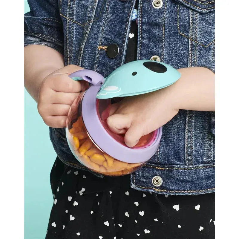 Koala-shaped snack cup with a clear base, designed for children, filled with goldfish crackers, held by a child.