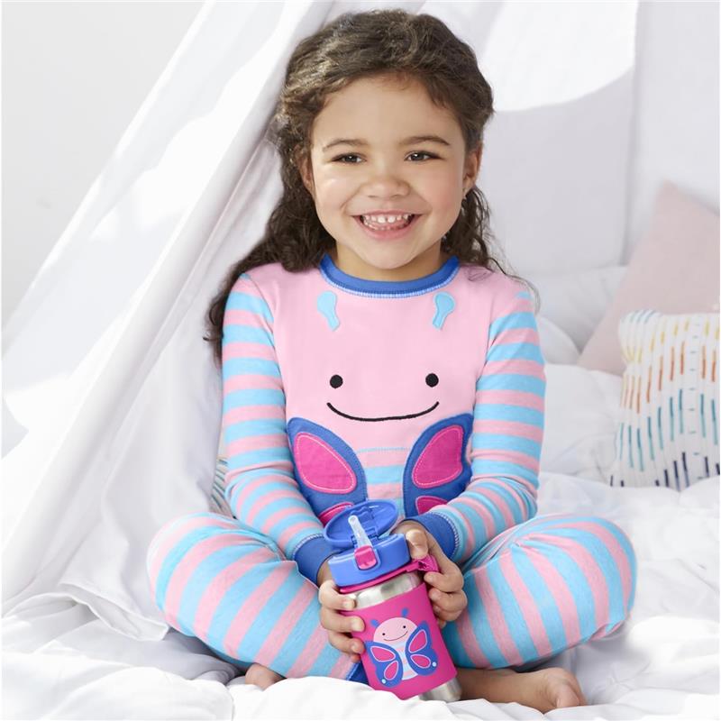 A smiling child wearing pink and blue striped pajamas holds a Skip Hop Zoo Octopus stainless steel straw bottle.