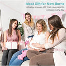 Four women celebrate at a baby shower, smiling and sharing gifts, with a pregnant woman admiring a small pink baby outfit.