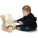 A toddler interacts with the Spin Master Animated Peek-A-Boo Bear, which has a cloth covering its face.