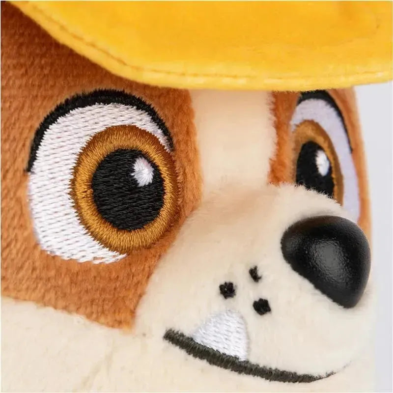 Plush toy of Rubble from PAW Patrol, featuring a brown and white face, big eyes, and a yellow construction hat.
