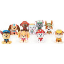 A collection of PAW Patrol plush toys featuring characters in their signature uniforms, designed for ages 1+.