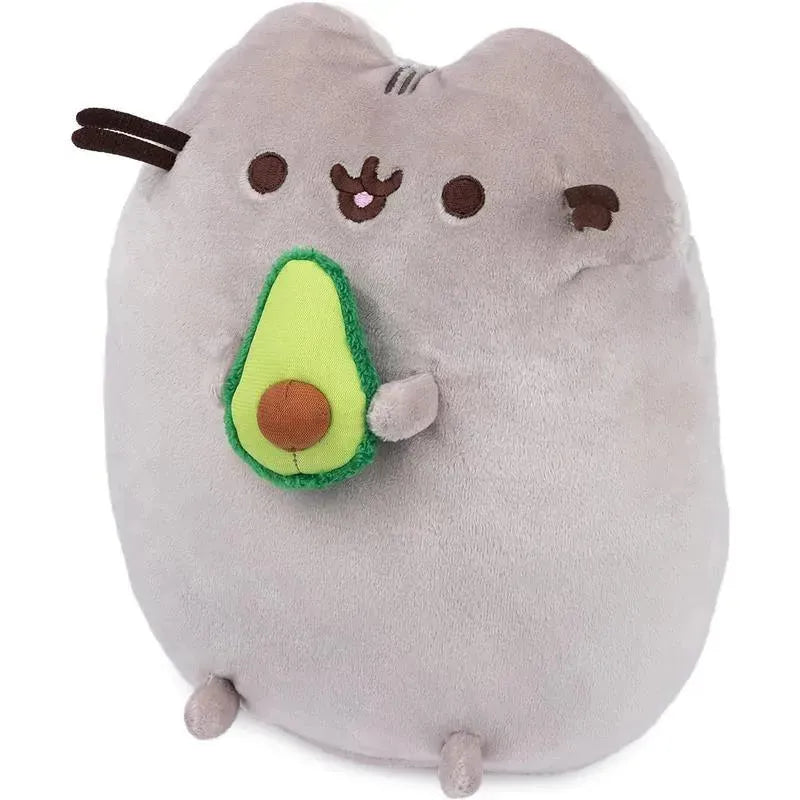 Gray plush Pusheen character holding a green avocado, designed as a cute snackable stuffed animal.
