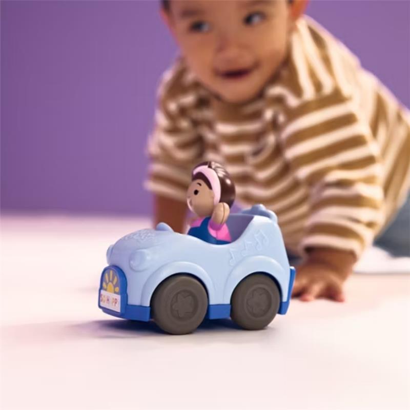 Blue toy car with a click-in figure inside, being played with by a child in a striped shirt.