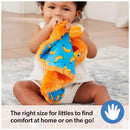 Child holding an orange plush security blanket with a blue banana print, promoting comfort for toddlers.