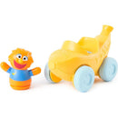 Spin Master Ms. Rachel figure alongside her yellow 1-2-3 Roll! vehicle, featuring a pull design and rolling wheels.
