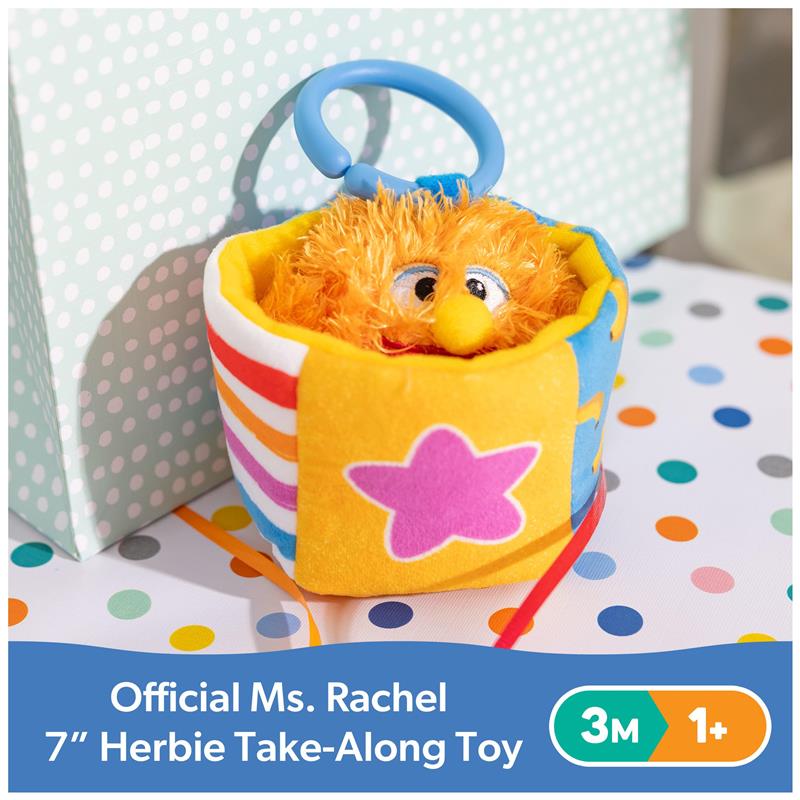 7-inch Ms. Rachel Herbie sensory take-along toy with orange plush fur, blue handle, and colorful patterned container.
