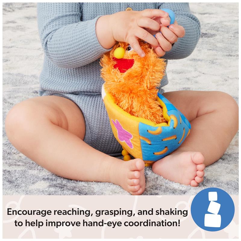 Child holding the Spin Master Ms. Rachel Herbie Sensory Take A Long Toy, promoting hand-eye coordination through play.