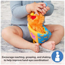 Child holding the Spin Master Ms. Rachel Herbie Sensory Take A Long Toy, promoting hand-eye coordination through play.