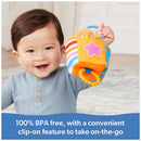 Child smiling while holding the Spin Master Ms. Rachel Herbie Sensory Take A Long Toy, designed for sensory play and portability.