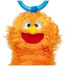 Ms. Rachel Herbie Sensory Take A Long Toy, featuring an orange, fluffy creature with a smiling face and a blue handle.