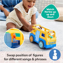Educational toy bus in bright yellow and blue, held by a smiling toddler. Features removable figures for interactive play.