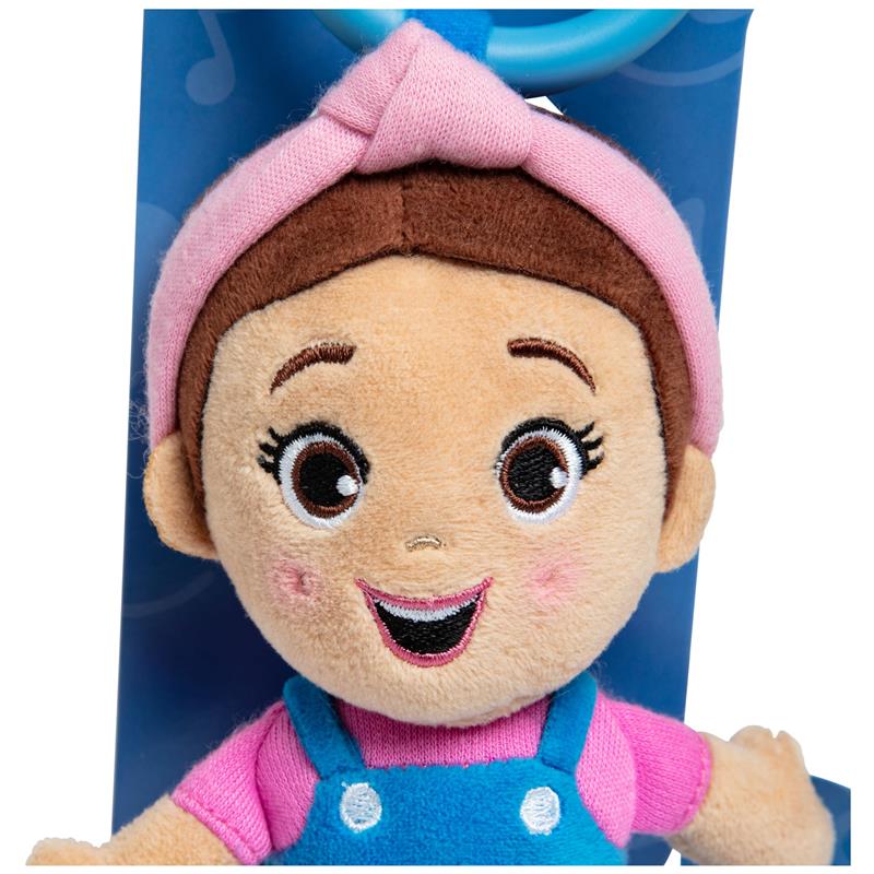 Smiling plush doll of a girl with brown hair and a pink headband, wearing a blue outfit and holding a loop for carrying.