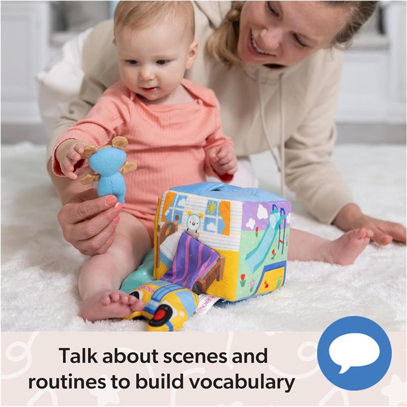 A baby plays with the Spin Master Ms. Rachel Surprise Learning Box while being engaged by an adult, encouraging vocabulary building.