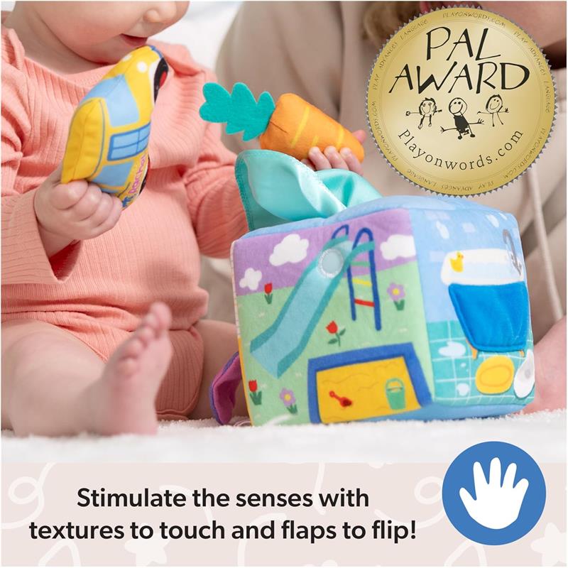 Colorful fabric learning box with various textures, a carrot toy, and a bird toy, promoting sensory play for infants.
