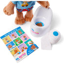 Plush teddy bear dressed in blue and red, with a mini potty, a roll of toilet paper, and a colorful instructional card.