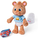 Plush teddy bear wearing a blue shirt with a car design, diaper, and red underwear, next to a potty, part of the Ms. Rachel toy line.