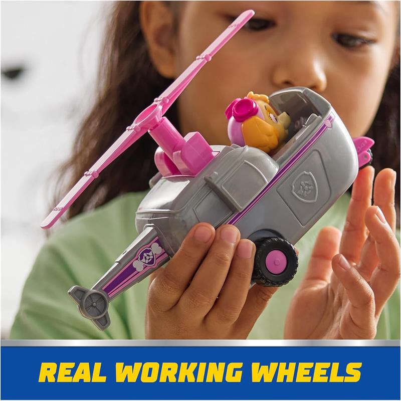 Paw Patrol toy car with collectible Skye figure, featuring working wheels and a pink propeller, held by a child.