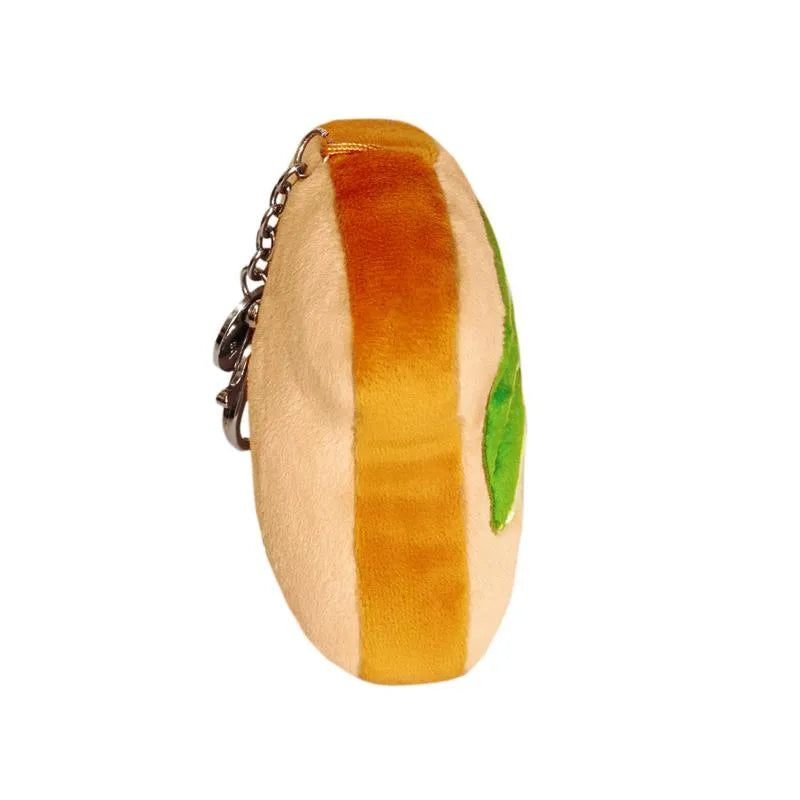 Metal clip keychain shaped like an avocado toast, featuring plush texture and vibrant green and brown colors.