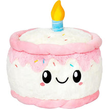 Soft plush cake with a smiling face, pink frosting, colorful sprinkles, and a lit blue candle on top.