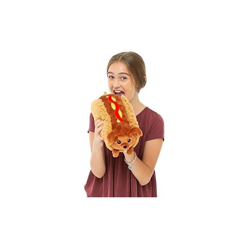 Plush Mini Squishable Dachshund Hot Dog being held playfully by a smiling girl in a burgundy shirt.