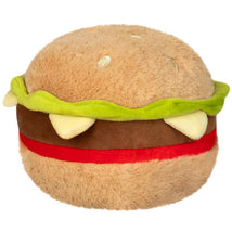 Plush hamburger toy with a soft, round shape, featuring lettuce, a red ketchup layer, and teeth-like elements.