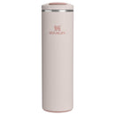 Stanley The Transit Fliptop Mug in Rose Quartz, 20 oz, with a sleek design and fliptop lid for easy drinking.