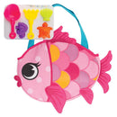 Pink fish-shaped tote bag with a blue handle, accompanied by colorful beach toys in various shapes.