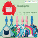 Colorful Stephen Joseph luggage tags featuring designs like a shark, mermaid, unicorn, and rainbow, with a red tag for personal information.