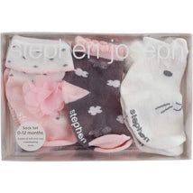 Three pairs of baby socks from Stephen Joseph in a clear box, featuring a pink pair with a flower, a dark pair with clouds, and a white pair with a bunny face.