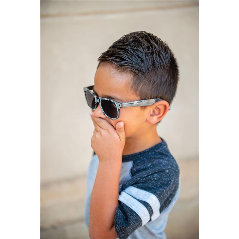 Child wearing Stephen Joseph Axolotl sunglasses, covering mouth with hand, showing playful expression.