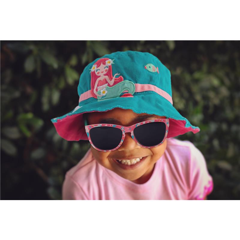 Young child smiling while wearing pink sunglasses and a teal bucket hat featuring a mermaid design.