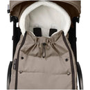Taupe Babyzen™ Yoyo footmuff featuring a soft, fluffy interior and drawstring closure for warmth and comfort in strollers.