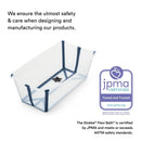 Stokke Flexi Bath Stand in grey, featuring a clear, rectangular tub with navy accents and a safety plug, certified by JPMA.