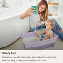 Stokke Flexi Bath Tub Bundle in sandy beige with a non-slip base, used by a woman and toddler enjoying bath time.