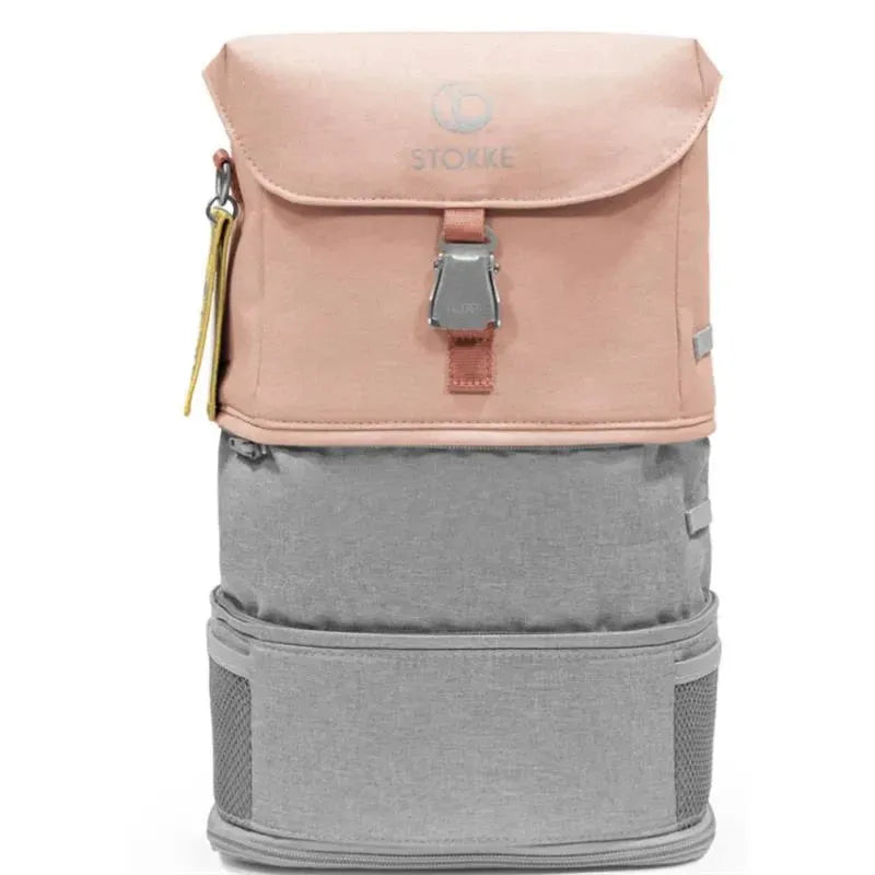 Stokke Jetkids Backpack in coral pink and grey, featuring a top flap, adjustable straps, and mesh side pockets.