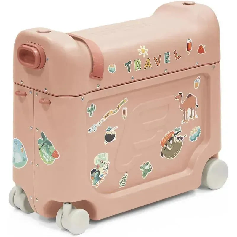 A Stokke Jetkids™ Bedbox™ in Midnight Grey with travel stickers, featuring wheels and a handle for mobility.