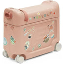A Stokke Jetkids™ Bedbox™ in Midnight Grey with travel stickers, featuring wheels and a handle for mobility.