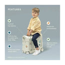 Kid sitting on a Stokke Jetkids™ Bedbox™ in Moonglow White, highlighting features like top-opening, swivel wheels, and personalization stickers.