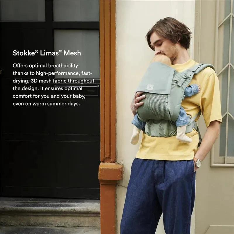 Stokke Limas™ Mesh carrier in Glacier Green, featuring a man holding an infant securely against his chest.